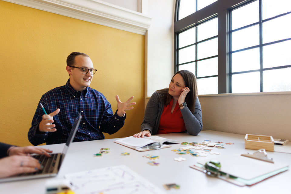 man and woman talking in classroom